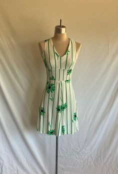 Adorable 1960's green daisy knit mini dress sundress featuring a V neckline, smocked waist and mod boho vibes! Dress zips up the back with a plastic zipper. The smocking at the waist is elastic that still has some give and retention. Dress is clean and in excellent condition! There is one 1/2" run at top of right front shoulder (not very noticeable), but felt I should mention. Label: Sears Jr. Bazaar  Measurements: would best fit a modern size XXS Bust= 30" Waist= 29" stretched Hip= 33" Shoulder width= 11" Body length from side neck down to hem edge= 35 1/2" Boho Hippie Style, Green Daisy, Mod Dress, Smocked Dress, Knit Mini Dress, Boho Vibe, Hippie Style, Dress Clothes For Women, Boho Dress