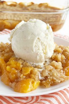 the best peach crisp without oats on a white plate with a scoop of ice cream