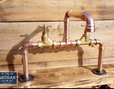 two faucets are sitting on a wooden bench