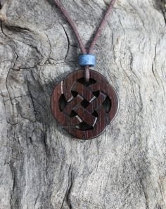 This beautiful and unique hand-carved Celtic Infinity pendant will be made for you, or a loved one, in my studio on the West of Ireland. This delicately carved Celtic necklace features a piece of Rosewood, recycled from musical instruments constructed by a local luthier. As a musician myself, I take enormous satisfaction in creating a piece of jewellery whose inherent wood has previously featured in a beautiful hand-made guitar! Celtic knots date back to the 3rd to 4th century B.C. They were use Symbolic Carved Brown Jewelry, Traditional Mahogany Jewelry As Gift, Traditional Mahogany Jewelry For Gifts, Brown Carved Spiritual Jewelry, Traditional Handmade Mahogany Jewelry, Spiritual Brown Carved Jewelry, Carved Brown Jewelry For Gifts, Brown Carved Jewelry Gift, 5 Year Anniversary Gift