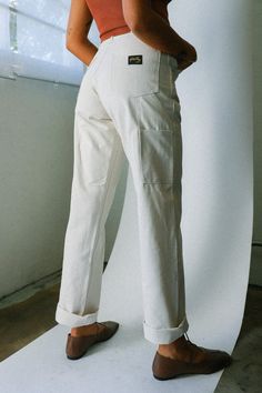 The OG Painter Pant is a relaxed fit pant constructed from smooth cotton sateen. These authentic painter pants feature robust workwear quality right down to the reinforced waistband and triple stitched leg seams. Made in the USA. Unisex sizing, model is 5'8" with a 26" waist and wearing a size 26. This style runs narrow through the hips and bottom, if you are in between sizes we recommend sizing up. Materials: 100% Cotton Painter Pants Women, Relaxed Fit Cotton Bottoms With Contrast Stitching, Cotton Bottoms With Contrast Stitching And Relaxed Fit, Straight Leg Cotton Bottoms With Contrast Stitching, Relaxed Fit Cotton Work Pants With Straight Leg, Relaxed Fit Cotton Work Pants, Relaxed Fit Work Pants With Straight Hem, Cotton Straight Leg Bottoms With Contrast Stitching, Cotton Work Pants With Relaxed Straight Leg Fit