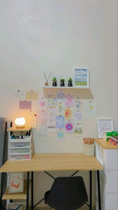 an office desk with lots of papers on it and a lamp next to the desk