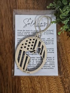 a wooden ornament with an american flag on it sitting on top of a book