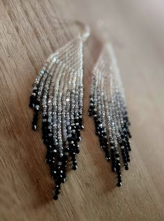 These grey to black ombre beaded earrings are handmade with high quality glass beads imported from India and are finished with silver plated ear wires. Earrings have an irridecent sparkle to them.  They measure 4 inches in drop length and weigh 4 grams per earring. They are  lightweight. Ships within 2 business days of purchase. Silver Beaded Earrings For Evening, Gray Beaded Dangle Earrings, Silver Adjustable Long Drop Beaded Earrings, Long Drop Beaded Earrings For Party, Party Long Drop Beaded Earrings With Ear Wire, Silver Long Drop Beaded Earrings, Elegant Silver Beaded Earrings With Black Beads, Silver Beaded Dangle Earrings With Faceted Beads, Adjustable Silver Beaded Earrings With Black Beads