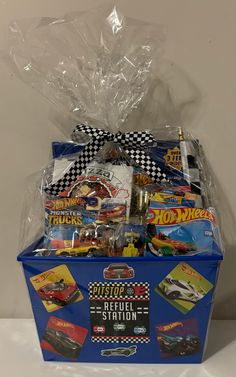 a blue gift box filled with hot wheels toys