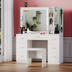 a white dressing table with a mirror and stool