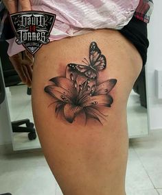 a woman's thigh with a butterfly tattoo on it