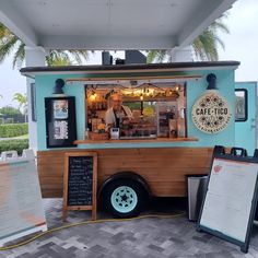 the food truck is parked on the side of the road with menus in front of it