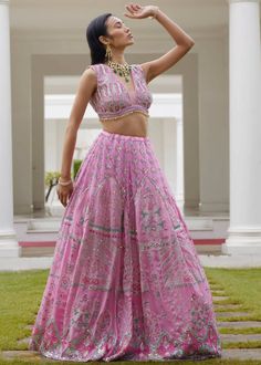 This modern lehenga in pastel hues features geometric and floral prints highlighted with embroidery detailing. The blouse comes with a deep V neckline adorned with beads and sequins all over. A cape with gathers is added to give you that chic look in an ethnic wear. Georgette Choli With Mirror Work And Cape Sleeves, Bollywood Style Lehenga With V-neck And Mirror Work, Cape Sleeves Sets With Mirror Work For Reception, Designer Bollywood Lehenga With V-neck, Bollywood Style V-neck Lehenga For Designer Wear, Elegant Multicolor Sequined Sets, Elegant Multicolor Sequin Sets, Designer Lehenga With Sequins And Cape Sleeves, Festive Lehenga With Mirror Work And Cape Sleeves