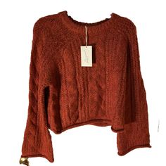 Elevate your winter and fall wardrobe with this Universal Thread from Target Women's Cable Knit Crewneck Sweater. The tag says the color is red BUT this is not a true red. More of a brownish oranges red. The sweater features a beautiful loose cable-knit pattern with bell sleeves and a rolled hemline for a chic and modern touch. The warm cozy soft heavyweight sweater is made of a knit fabric of polyester and acrylic, making it comfortable to wear while keeping you warm in colder weather. Raglan sleeve with bell and rolled cuffs. Oversized. This sweater is perfect for casual occasions and can be styled with jeans and sneakers. The sweater is machine washable, and the size is regular fit. MSRP $30 Please follow as I add additional women’s sweaters in various sizes, styles, and colors separate Casual Knitted Burgundy Sweater, Casual Burgundy Knitted Sweater, Red Long Sleeve Cropped Sweater, Casual Red Cropped Long Sleeve Sweater, Trendy Red Sweater For Fall, Casual Red Cropped Sweater For Winter, Casual Burgundy Sweater For Fall, Fall Cropped Crew Neck Knit Sweater, Red Knit Cropped Sweater With Long Sleeves