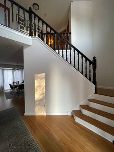 an empty living room with stairs leading up to the second floor