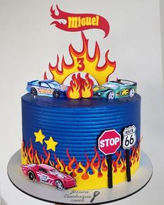 a birthday cake with hot wheels on top