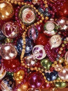 a bunch of ornaments that are laying on the ground together, all in different colors and sizes