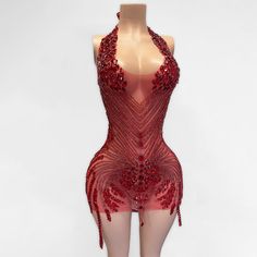 a mannequin wearing a red dress with sequins on it