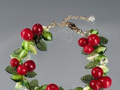 "Red Berry Bracelet *red berries aka Pepper Berries or Holly Berries *hand blown glass beads in several shades of red *surrounded by a wreath of different color green glass beads *decorated length is 7 inches *49-strand stainless steel beading wire for strength *your choice of sterling silver or 14/20 gold-filled chain and parts *clip lobster into any link to adjust the length *expect minor variations in shape, size and colors of each glass item *your bracelet will be very similar but not exactl Berry Bracelet, Pepper Berries, Weave Bracelet, Bead Woven Bracelet, Feminine Earrings, Casual Earrings, Orange Agate, Holly Berries, Woven Bracelets