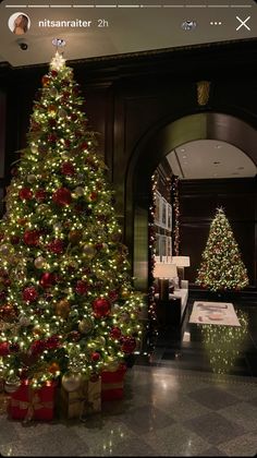 a decorated christmas tree in the middle of a lobby