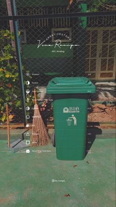 a green trash can sitting next to a fence