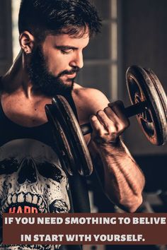 a man holding a barbell in front of his face