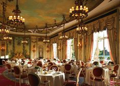 a fancy dining room with chandeliers and tables