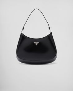 Brushed leather Leather handle Metal hardware Logo on enameled metal triangle at the front Magnet closure Prada logo nylon lining with patch pocket Black Prada Bag, Prada Cleo, Prada Purses, Prada Collection, Prada Shoulder Bag, Prada Logo, Prada Leather, Black Shoulder Bag, Prada Handbags