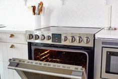 an oven with the door open in a kitchen