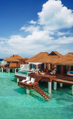 the water is crystal blue and clear with some huts on it's docks