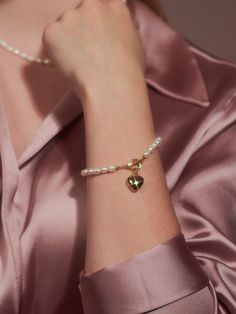 Editor's NotesENGBROX's jewelry is gorgeous and perfect for everyday wear.- Light-weighted- Eye-catching heart pendant detail- Pearl chain band- T-bar closure- Perfect for layering- Minimal and feminine stylesMeasurements(in.)- Size: 5.91in. (L)- Heart: 0.47in.- Toggle: 0.35in. outer diameter- Weight: 0.39oz.Composition & Care- Brass, Epoxy, Freshwater Pearl- Avoid direct heat and moisture- Professional cleaning is recommendedDesigner- by ENGBROX Elegant Everyday Heart Bracelet With Charms, Elegant Everyday Jewelry With Heart Beads, Heart-shaped Jewelry With Clasp For Gifts, Heart-shaped Jewelry Gift With Clasp, Feminine Heart-shaped Everyday Jewelry, Heart-shaped Pearl Charm Bracelets For Weddings, Gift Pearl Bracelet With Heart Beads, Metal Jewelry With Heart Beads, Heart-shaped Pearl Bracelet For Gift