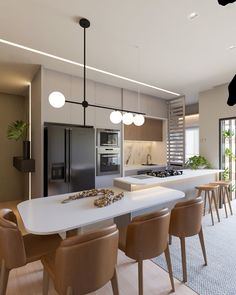 a modern kitchen and dining room with an island in the middle, surrounded by stools