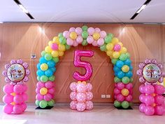 balloons are arranged in the shape of flowers and numbers for an entrance to a children's birthday party