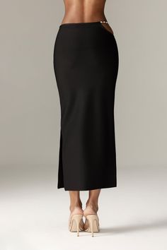 Our 'Star' midi skirt looks so chic paired with our 'Stella' top.It's luxuriously soft bandage in a slim, that hugs your curves in a classic and ultra flattering pencil silhouette, 'Star' has a comfortable flexible waistband that sits low on the natural waist and it has side zipper for easy wear and designed with an open curved side with dangling rhinestone chains for a daring flash of skin. WHERE TO WEAR: Stylish dinner dates, champagne bars, after work drinks, parties. TEAM YOURS WITH: Stella Stretch Midi Length Bottoms For Date Night, Stretch Midi-length Bottoms For Date Night, Elegant Bodycon Lined Skirt, Classic Fitted Midi Skirt, Fitted Modern Maxi Skirt With Lined Skirt, Fitted Modern Lined Maxi Skirt, Modern Fitted Lined Maxi Skirt, Elegant Bodycon Pencil Skirt For Night Out, Elegant High Waist Fitted Skirt