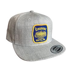 The iconic Kingdome affixed to the front of a Yupoong brand adjustable snapback hat. Choose curved or flat brim. Adjustable Snapback Hat With Curved Brim For Baseball Season, Adjustable Curved Brim Snapback Hat For Baseball Season, Trucker Hat With Logo Patch For Sports Events, Urban Trucker Hat With Logo Patch And Flat Bill, Urban Trucker Hat With Flat Bill And Logo Patch, Urban Trucker Hat With Logo Patch, Trucker Snapback Hat With Curved Bill For Baseball Season, Trucker Snapback Hat With Curved Brim For Sports, Urban Snapback Baseball Cap With Logo Patch