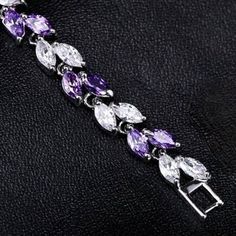 Romantic. Classy. Delicate. Rhodium plated for a flawless finish which perfectly enhances the intricate detailing, this exquisite bracelet will add a touch of sophistication to any wedding gown or formal ensemble. Each link is adorned with flawlessly faceted purple and clear cubic zirconia that capture the light from every angle with a perfectly translucent appeal, sparkling beautifully. Available in two lengths: 6.5" (approx. 16.5cm) and 7.75" (approx. 19.6cm). To make your choice select your p Purple Crystal Bracelet, Bracelet Wedding, Purple Crystal, Matching Jewelry, Bridal Bracelet, Purple Crystals, Wedding Bracelet, Crystal Bracelets, Wedding Gown