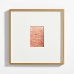 an abstract painting in a wooden frame on the wall