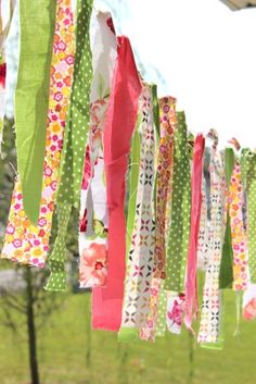 many different colored ribbons hanging from a line