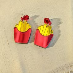 Yummy salty fries in an iconic red take out container. They are shiny and reflective to add a little extra sparkle to your life. Order with the Default Stud to get the earring as pictured. If you would prefer an ear wire or hook, choose the Ear Hook option. Each earring measures 1.5 inches (3.8 cm). Earring posts are quality hypoallergenic stainless steel for sensitive ears. Materials: Acrylic Hypoallergenic Stainless Steel Yellow Statement Earrings, Take Out Containers, Mirror Acrylic, Food Jewelry, Earring Posts, Ear Hook, French Fries, Wood Jewellery, Sensitive Ears