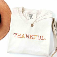 Cute Thankful Shirt 🍁 IMPORTANT INFORMATION This t-shirt is really soft and comfortable to wear. You will love it!  You can tuck or tie a knot at the bottom for a stylish put together look.  Wear it which ever way you want. 🙂 MATERIALS/FABRIC  Solid Colors: 100% combed and ring spun cotton, 30 single, 4.2 oz.  The double-needle stitching throughout the tee makes it highly durable  while the lack of side-seams helps the shirt retain its tubular shape. SIZING AND COLOURS  You will find the sizing and colour chart in the images. The style of t-shirt is unisex, boyfriend fit. HOW TO CARE FOR THE T-SHIRT Always turn the t-shirt inside out before putting into the machine.Wash cold on delicate cycle (max 30C or 90F) Dry on low heat setting or air dry Please do not not dry clean Do not iron dire Grateful Shirt, Thankful Shirt, Fall Shirts Women, The Only Exception, Thanksgiving Shirts, Comfort Color, Retro Shirts, Boyfriend Fit, Fall Shirts