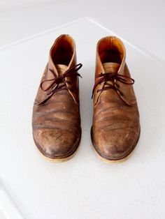 This is a pair of vintage Red Wing leather work boots.  Rich brown leather shapes the boots.  The boots have rubber soles and are marked with the Red Wing tag inside the boot.  A rare size.CONDITIONIn good condition with wear consistent with age and use.MARKED SIZE:  13 DMEASUREMENTSInsole Length: 11.875" ... 30.2 cmWall to Toe Length:  12.875" ... 32.7 cmWidth:  4.5" ... 11.4 cmHeight:  5.5" ... 13.9 cmFor best fit, please compare measurements with a boot of your own.  IC51805 Leather Work Boots, Leather Chukka Boots, Irish Setter, Vintage Clothing Online, Red Wing, Leather Work, Red Wings, Boot Shop, Lace Boots