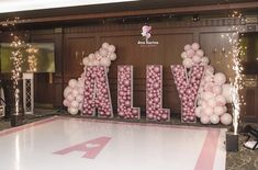 balloons spelling out the word ally in front of a dance floor