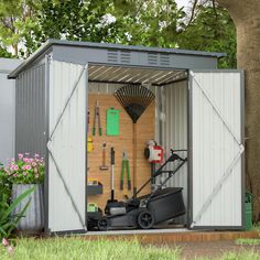 a garden shed with tools in it and the door opened to reveal an area for gardening