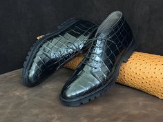 1. Handmade Alligator Textured Cowhide Leather Shoes Crafted from premium, alligator-textured cowhide leather, these shoes are a must-have for men seeking luxury and individuality. 2. Unique, Artisan-Crafted Design Each pair is uniquely handcrafted by expert artisans, offering a one-of-a-kind design that combines modern style with timeless elegance. 3. High-Quality Leather Upper Material The upper material is made from full-grain leather, providing unmatched durability and a sleek, polished look Black Alligator, Leather Chukka Boots, Shoe Crafts, Custom Shades, Boots For Men, Men's Footwear, Modern Gentleman, Mens Oxfords, Stylish Shoes