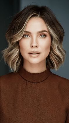 This ash blonde bob features face-framing highlights that add a modern touch. The wavy bob is chic and stylish, paired with a high-necked, rust-colored dress. The indoor, professional backdrop enhances the polished look. I’m excited to offer this contemporary, sophisticated style to clients looking for a fresh update. Blonde Highlights On Dark Hair Short Bob, Short Bob With Face Framing Highlights, Ash Face Framing Highlights, Framing Face Highlights, Short Hair Face Framing Highlights, Silver Face Framing Highlights, Bob With Face Framing Highlights, Face Framing Highlights Short Hair, Face Highlights Hair