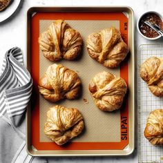 freshly baked croissants on a baking sheet