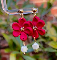 red flower earrings with pearls hanging from them