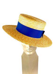 Straw boater hat made with 8/9 millimeters natural straw braid. Embellished with a 50 millimeters wide blue grosgrain ribbon. You can choose the grosgrain ribbon in the color you like best - (in this ad the grosgrain is azure) Measurements in centimeters are 34 x 32. Crown height 9. Brim length 7. These measurements may have some slight variation depending on the size of the hat. For its elaboration we only use very good quality and resistant straw braids. In our workshop in the Pyrenees we sew Gold Flat Brim Hat Bands For Summer, Gold Hat Bands With Flat Brim For Summer, Handmade Gold Summer Hats, Gold Short Brim Panama Hat For Summer, Gold Straw Hat For Summer, Gold Panama Hat With Flat Brim For Summer, Gold Flat Brim Panama Hat For Summer, Handmade Elegant Hat Bands For Beach, Handmade Elegant Hat Bands For The Beach