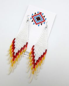 "Modern White Red and Orange Native American Style Seed Bead Earrings Powwow Bling Ethnic Chic Handmade Free Shipping. Amazing colors combined in a Modern Powwow Native American Style Seed Bead Earring set. Great new bling design with great colors and styling. Stainless steel ear wires and genuine high quality beads. Over 4\" drop great for any person. A beautiful combination of colors and native design at a super price. All handmade. Shipped Free from Hawaii with Aloha!" White Southwestern Beaded Earrings For Festivals, White Southwestern Style Beaded Earrings For Festival, Southwestern White Beaded Earrings For Festival, White Southwestern Beaded Earrings, Southwestern Style White Earrings For Festivals, Southwestern Style White Jewelry With Dangling Beads, White Southwestern Handwoven Jewelry, Red Handwoven Beaded Earrings For Festival, Southwestern Style Large White Beads