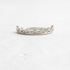 a white gold wedding band with five diamonds