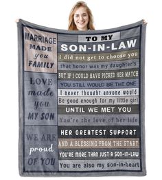 a woman holding up a blanket that says, to my son - in - law