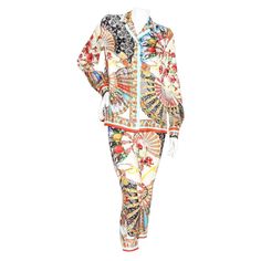 Product Details: Silk print pant suit by Dolce & Gabbana Multicolor print Fan print with Sicilian figures Blouse: Pointed collar Long sleeve Button closure cuffs Button front closure Fluid silhouette Pant: Mid rise Flat front Fitted legs Zip side with hook and eye closure Made in Itay Condition: Good, some loose strings. Pulls in fabric throughout. Sold as is. (see photos) Size/Measurements: Size 42IT 38" bust 39" waist 25.5" length Pant: 27" waist 30" hip 34" pant length Patterned Long Sleeve Printed Sets, Patterned Long Sleeve Floral Print Set, Patterned Floral Print Long Sleeve Set, Long Sleeve Digital Print Sets For Work, Fitted Digital Print Patterned Sets, Fitted Patterned Set With Digital Print, Fitted Patterned Sets With Digital Print, Digital Print Long Sleeve Sets For Workwear, Long Sleeve Patterned Set With Floral Print