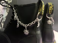 Welcome to this listing for our awesome stainless steel Sun & Moon boot chains! - Stainless steel boot chains (Thick amazing quality!) - 4 Sun & Moon charms on each boot. - Stainless steel boot clip to hang off the back tag 2.5cm x 2.5 cm - Photographed on UK size 6 Dr Marten 1460 to give you and idea how they will look on your boots! - These can also be used as a cool bag/jeans chain or on other boots like Demonia or New rocks. - These come as a pair, one for each boot. These would make a fabulous gift for someone who loves their Dr Martens or a cheeky treat for yourself!   BOOT CHAINS COME IN AUTBOX ORGANZA GIFT BAG WE HAVE MATCHING NECKLACES AND BOOT CHARMS PLEASE SEE OUR OTHER LISTINGS. IF YOU HAVE ANY QUESTIONS POP ME A MESSAGE, IM ALWAYS HAPPY TO HELP. :) Steel Boots, Boot Charms, Jeans Chain, Dr Martens Style, Martens Style, Boot Chains, Bag Jeans, Moon Boot, Witchy Fashion