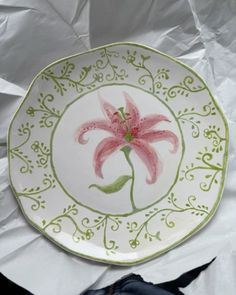 a plate with a pink flower painted on it